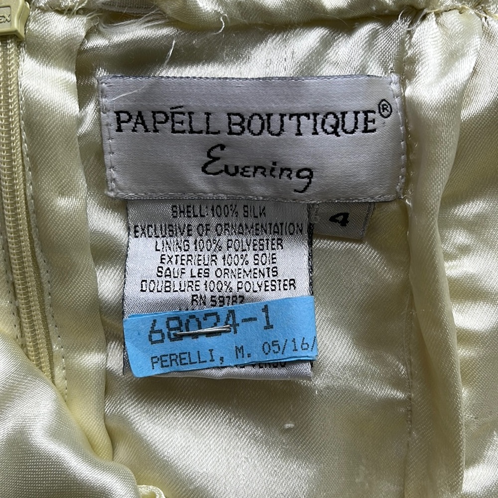 Pencil crisscross back yellow prom dress beaded with slit in the back .